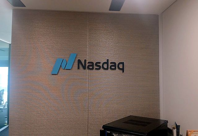 Logo on a textured feature wall – Financial services · office logo wall